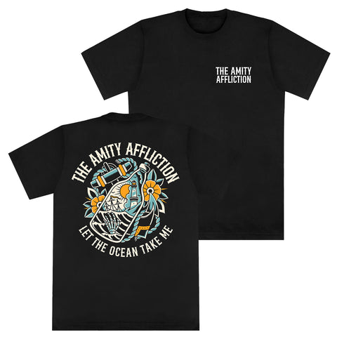 Black Comfort Colors T-shirt by The Amity Affliction with band text on the front left chest; back print features a skeleton hugging an anchor with flowers, plus "THE AMITY AFFLICTION" and "LET THE OCEAN TAKE ME" text.