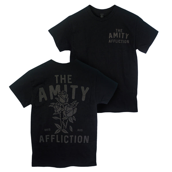 Two black The Amity Affliction t-shirts in 100% cotton feature a small chest logo and large rose graphic with "The Amity Affliction BRIS AUS" on the back, offering a classic fit.