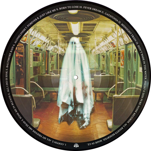Image of a picture disk vinyl against a white background. The artwork features a ghost in the center of the disk, standing inside of a subway train. The subway has green walls and doors, and all of the seats are empty. The lighting is yellow. Around this image is the tracklisting for the amity affliction's album- everyone loves you... once you leave them.