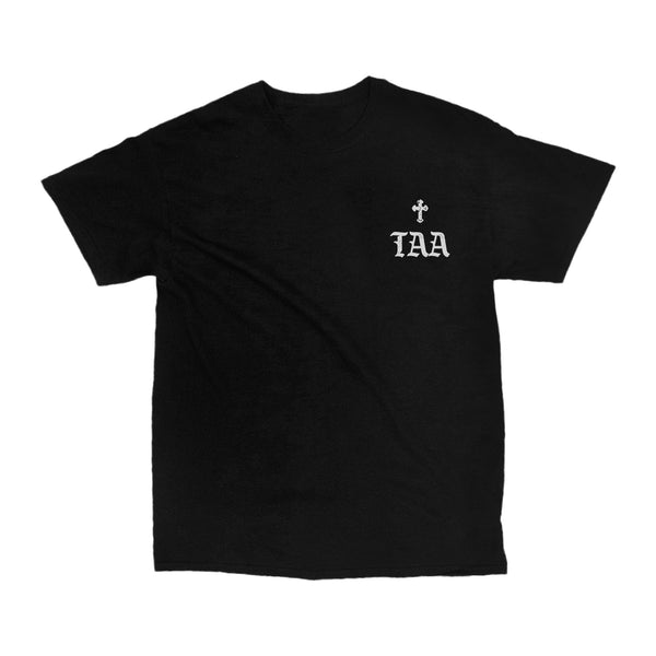 image of the front of a black tee shirt on a white background. tee has a small right chest print in grey that has a small cross and the letters T A A.