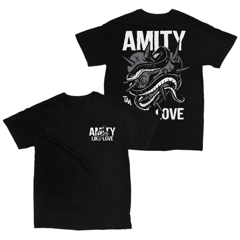 Image of the front and back of a black tshirt against a white background. The front of the shirt says Amity, and below that it says like love. This is in white. There is a snake wrapped around the words. The back of the shirt across the shoulder in bold white writing says Amity. The center of the shirt features an image of a grey spiked heart with a snake wrapped around it. the bottom of the shirt says taa like love in white.