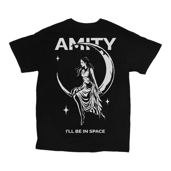 Image of the back of a black tshirt against a white background. The back of the tshirt says Amity across the shoulders in white text. There is a large graphic of a crescent moon with a woman in a dress sitting on it, looking to her left. she is surrounded by several stars. Below this graphic in white text it says I'll be in space.